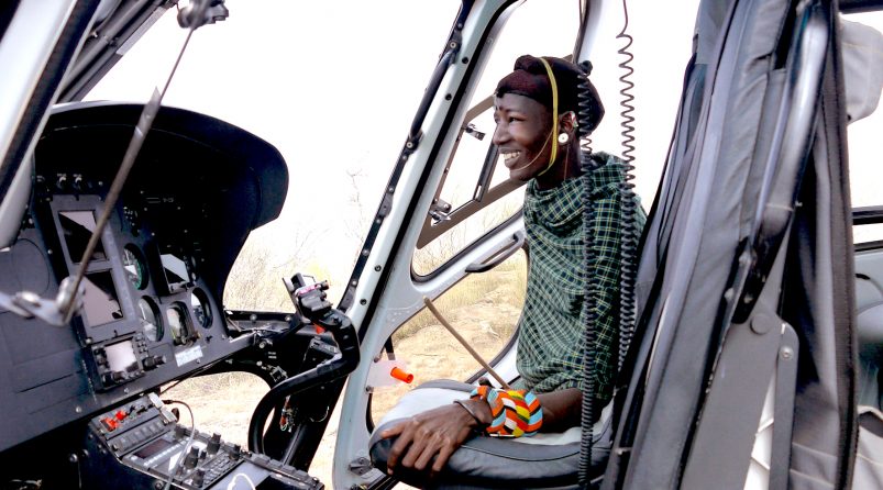 Samburu warrior looking inside the Helicopter