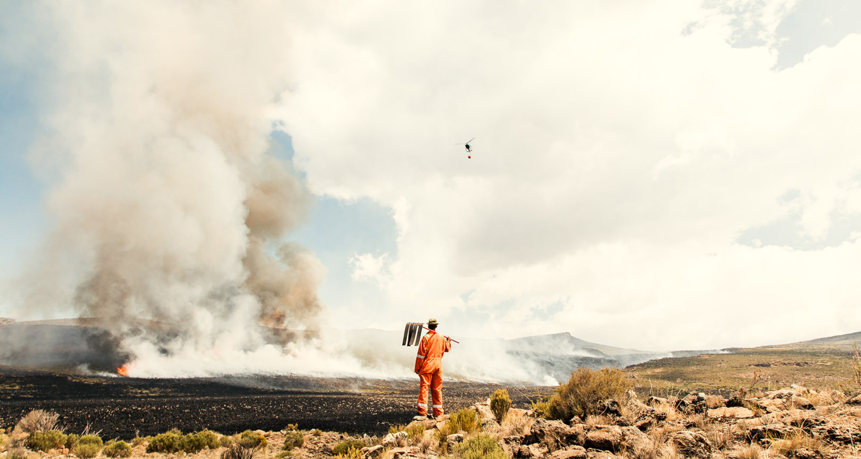 Man fighting fire on Mount Kenya